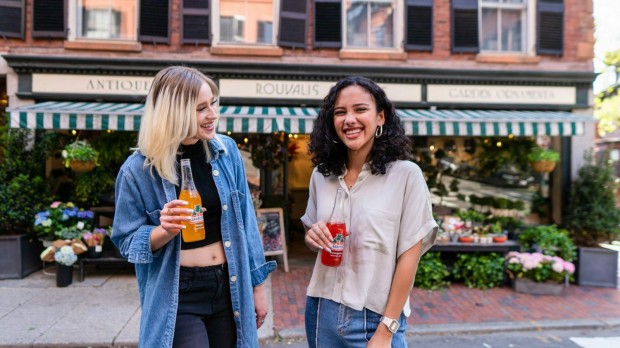 two girls sharing sodas