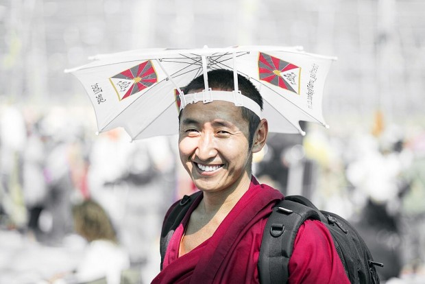 monk wearing an umbrella hat 