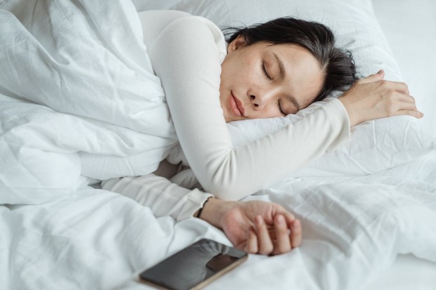 woman sleeping with her phone on the side