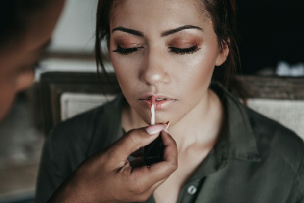 girl applying lip gloss